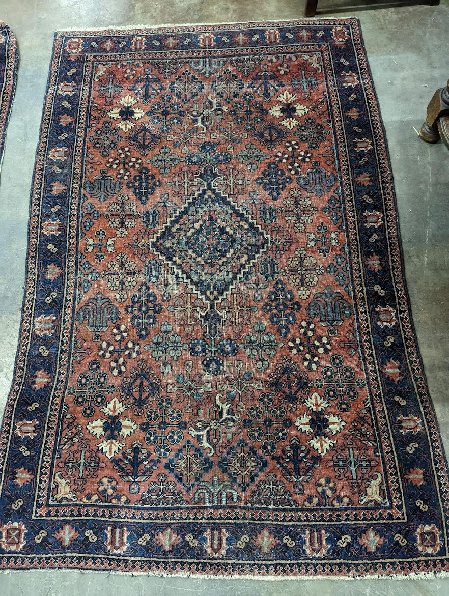 A pair of Caucasian red ground rugs, 200 x 134cm